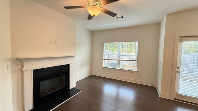 32 S Auburn Landing Pl, Auburn, GA 30011 - unfurnished living room featuring dark wood-type flooring, a glass covered fireplace, baseboards, and a ceiling fan