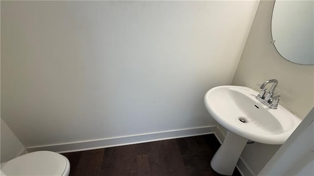 32 S Auburn Landing Pl, Auburn, GA 30011 - half bath featuring baseboards, wood finished floors, toilet, and a sink