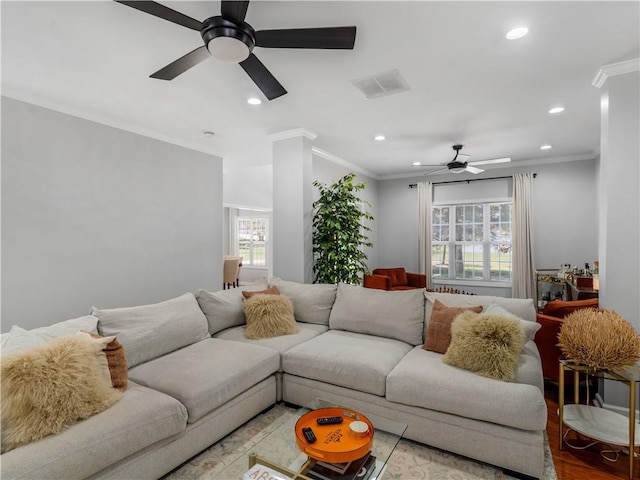 living room featuring crown molding, ceiling fan, and light wood-type flooring