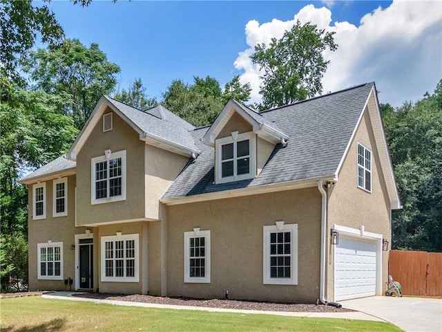 view of front of home featuring a garage and a front lawn