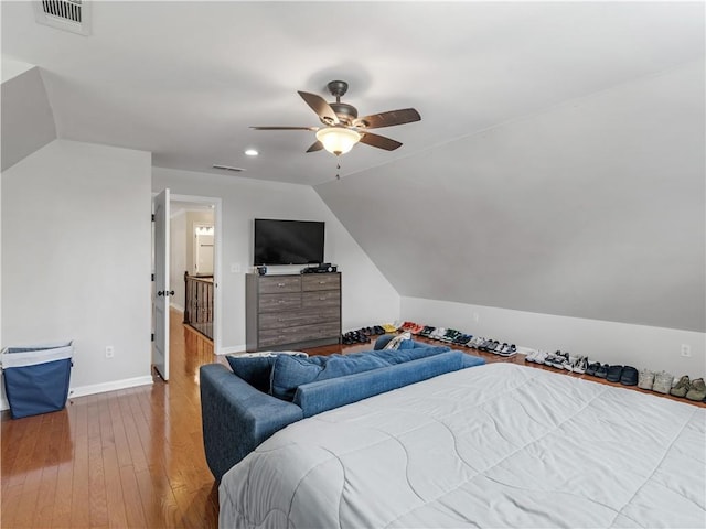 bedroom with hardwood / wood-style flooring, ceiling fan, and lofted ceiling