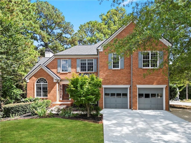 view of front of home with a front lawn and a garage