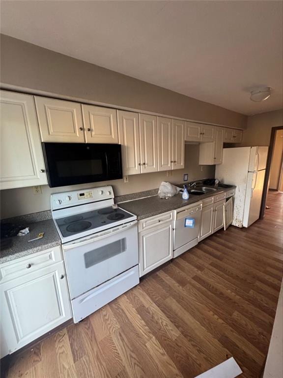 kitchen featuring white cabinetry, dark hardwood / wood-style flooring, sink, and white appliances