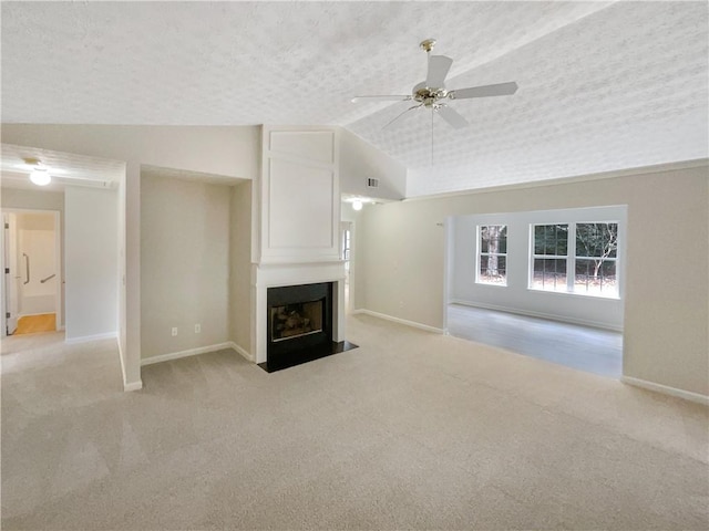 unfurnished living room featuring a fireplace, vaulted ceiling, light carpet, and a textured ceiling