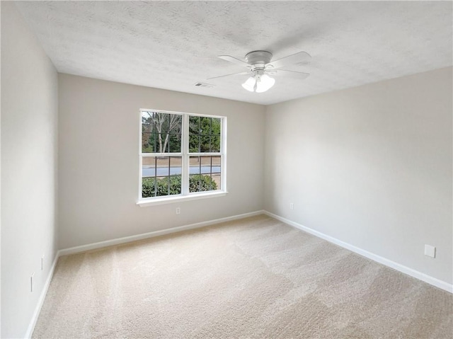 spare room with ceiling fan, carpet floors, and a textured ceiling