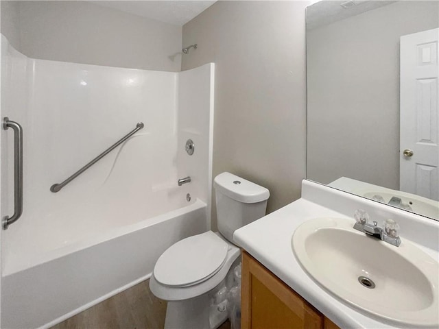 full bathroom featuring shower / bathing tub combination, vanity, toilet, and hardwood / wood-style floors