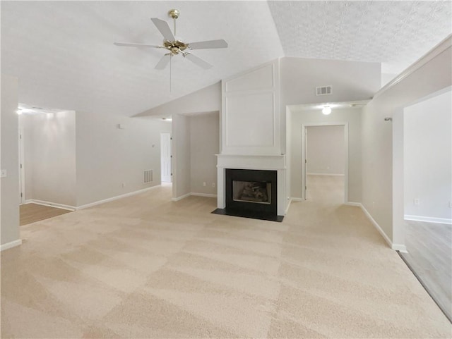 unfurnished living room featuring a fireplace, light carpet, vaulted ceiling, and ceiling fan