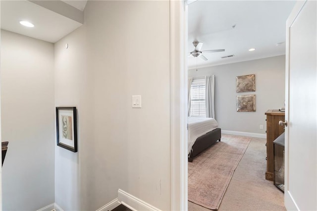hallway with baseboards, visible vents, carpet floors, and recessed lighting
