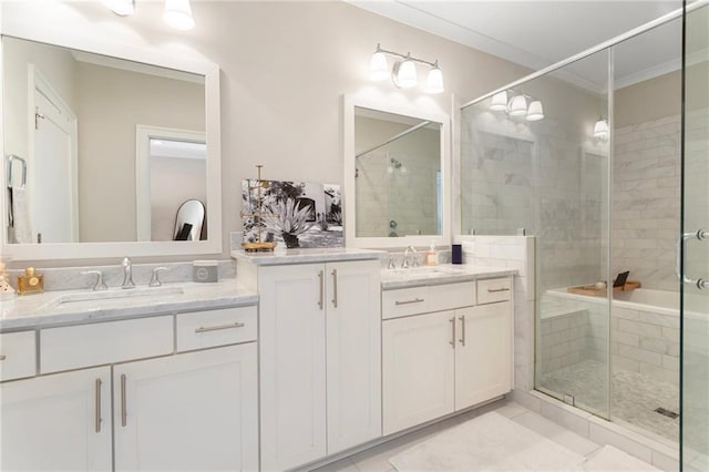 full bathroom featuring a stall shower, two vanities, tile patterned flooring, and a sink