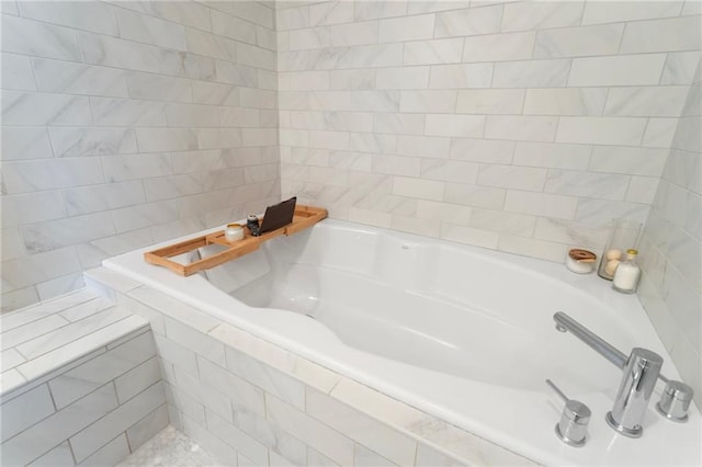 bathroom featuring tiled bath and tile walls