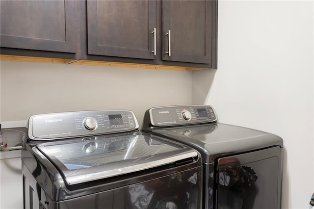laundry area with cabinet space and independent washer and dryer