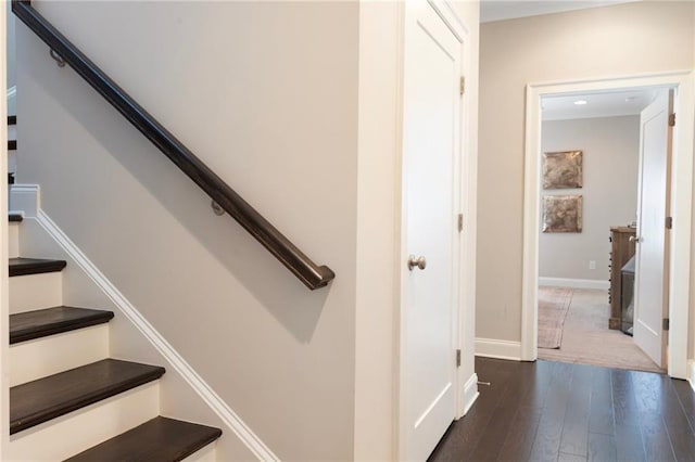 stairway featuring wood finished floors and baseboards