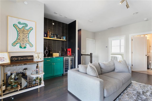 living room with wet bar, dark wood finished floors, and wine cooler