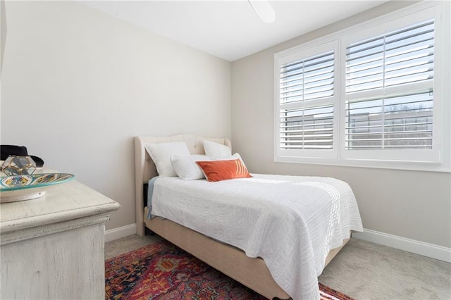 bedroom with light carpet and baseboards