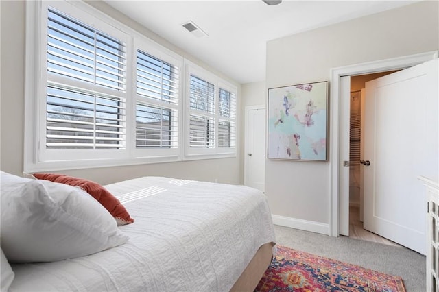 bedroom featuring baseboards, visible vents, and carpet