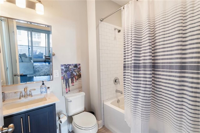 full bath with shower / bath combo with shower curtain, toilet, and vanity