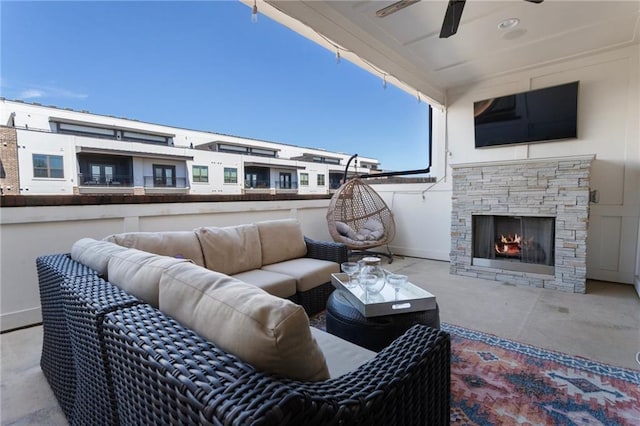 view of patio featuring an outdoor living space with a fireplace and a ceiling fan