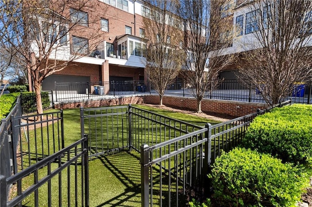 view of home's community featuring a yard, an attached garage, and fence