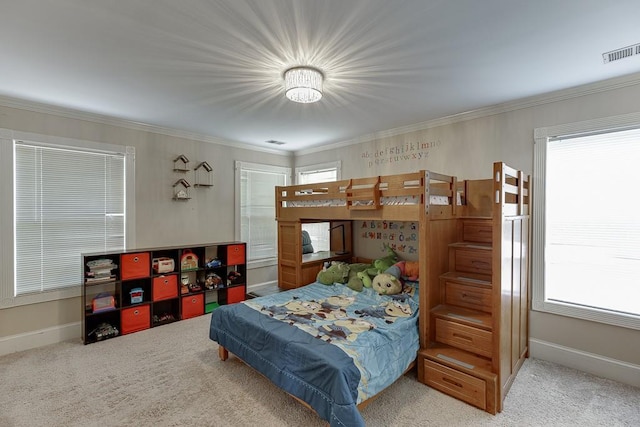 carpeted bedroom featuring baseboards, visible vents, and crown molding