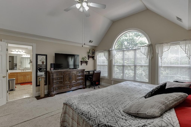 bedroom with light carpet, visible vents, a ceiling fan, vaulted ceiling, and ensuite bath