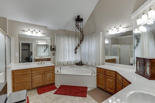 full bath with two vanities, a sink, vaulted ceiling, a shower stall, and a bath