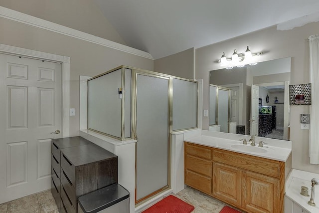 bathroom featuring vaulted ceiling, a stall shower, and vanity