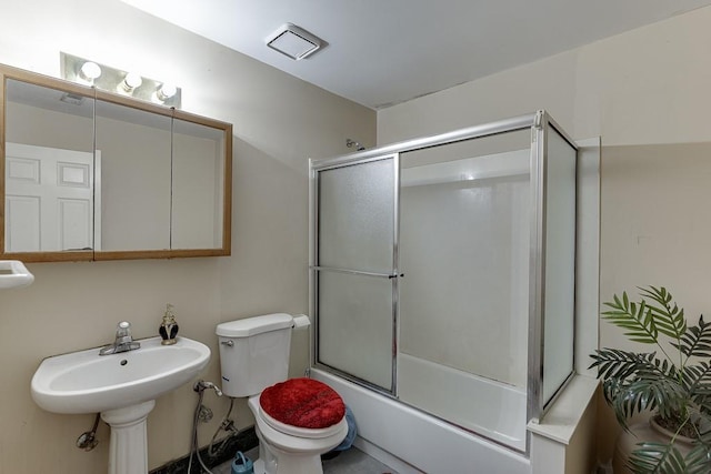 bathroom with combined bath / shower with glass door, visible vents, and toilet