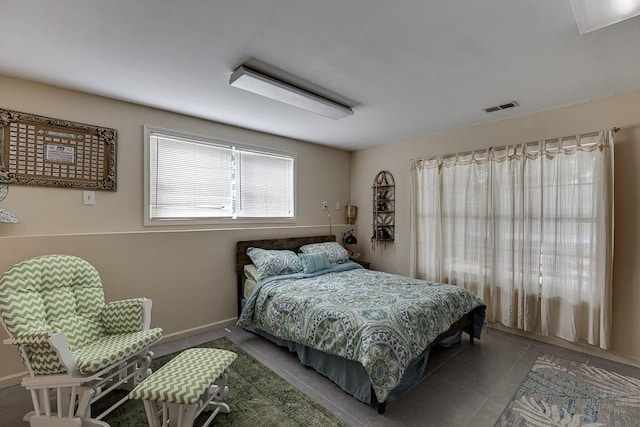 tiled bedroom featuring visible vents and baseboards