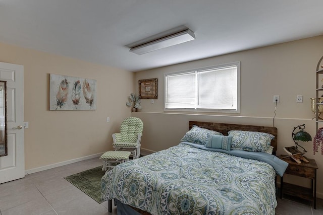 bedroom featuring baseboards and light tile patterned floors