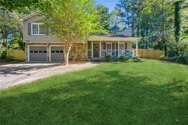 split level home with a front yard, a garage, and a porch