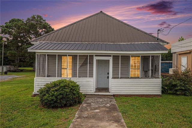 view of front of home with a yard and covered porch