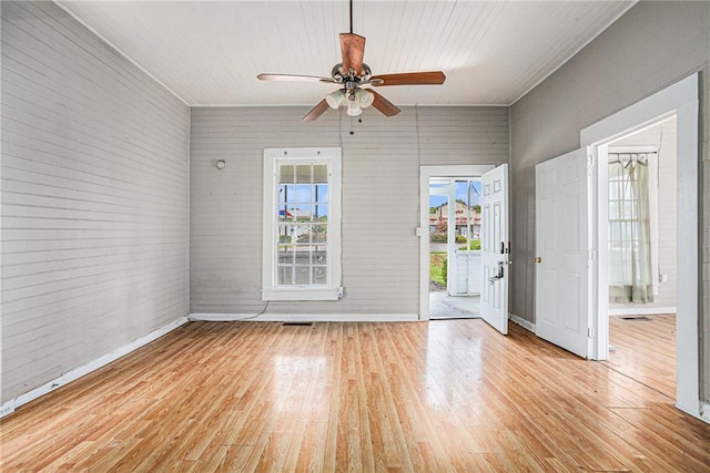 empty room featuring plenty of natural light, light hardwood / wood-style flooring, and ceiling fan