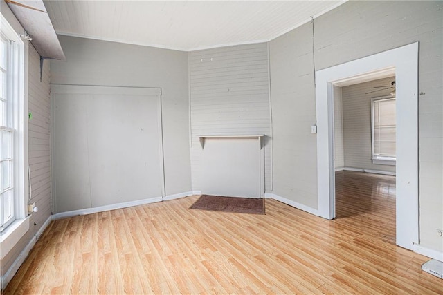 spare room featuring light hardwood / wood-style floors and ornamental molding