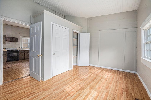 unfurnished bedroom featuring vaulted ceiling and wood-type flooring