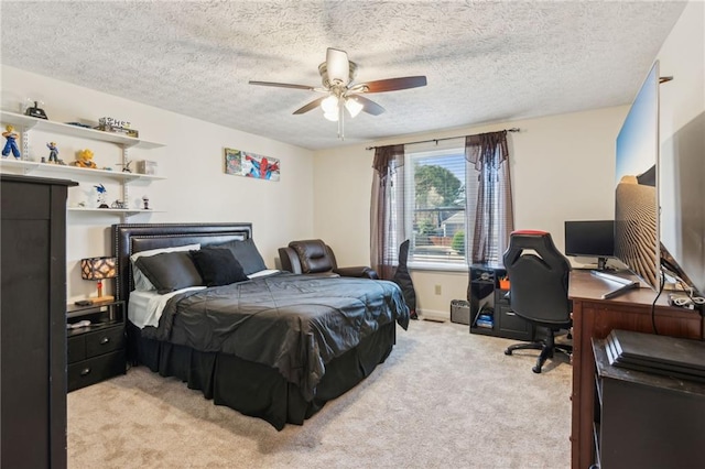 bedroom with a ceiling fan, a textured ceiling, and light colored carpet