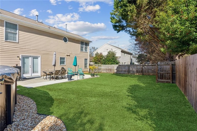 back of house with a yard, a fenced backyard, and a patio