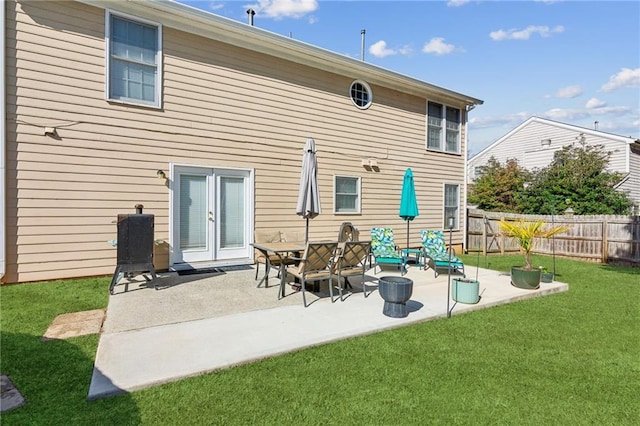 back of house featuring a yard, french doors, fence, and a patio