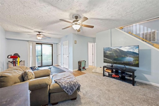 carpeted living room with ceiling fan and a textured ceiling