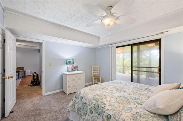 bedroom featuring ceiling fan, a tray ceiling, a textured ceiling, light carpet, and access to outside