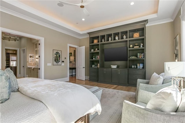 bedroom with a tray ceiling, crown molding, recessed lighting, and wood finished floors