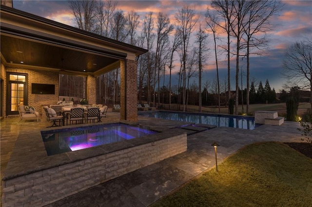 pool featuring a ceiling fan, a patio, and an in ground hot tub