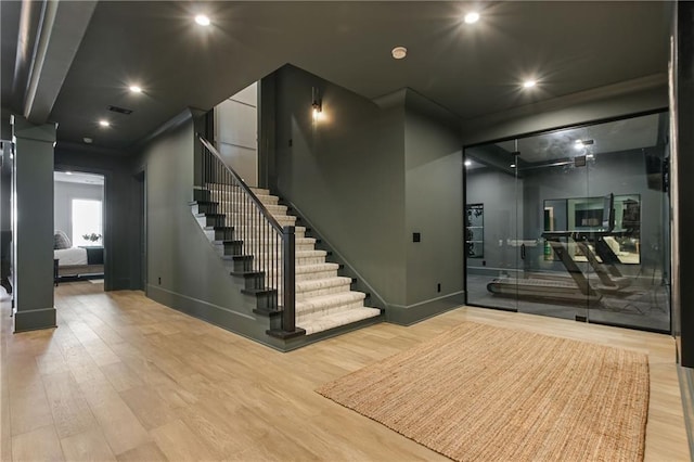 interior space with recessed lighting, wood finished floors, and baseboards