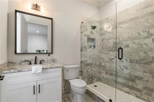 bathroom with toilet, marble finish floor, a shower stall, and vanity