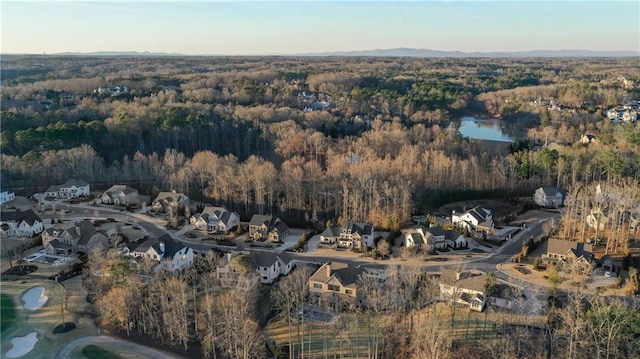 aerial view featuring a wooded view and a residential view