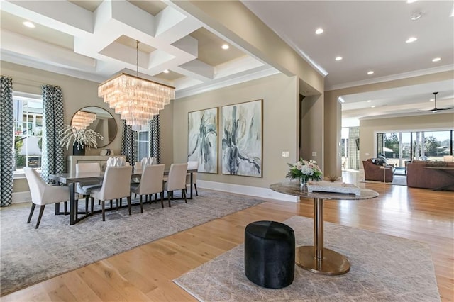 dining space featuring recessed lighting, coffered ceiling, ornamental molding, wood finished floors, and ceiling fan with notable chandelier