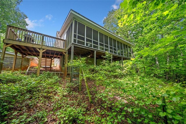 500 Nolan Rd, Carrollton, GA 30116 - back of house featuring a sunroom, a wooden deck, and stairs
