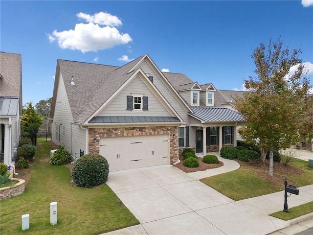 craftsman house featuring a garage and a front lawn