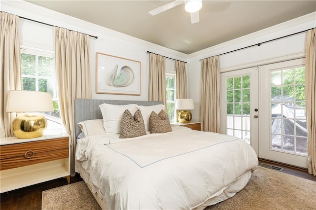 bedroom featuring access to outside, wood finished floors, french doors, and a ceiling fan