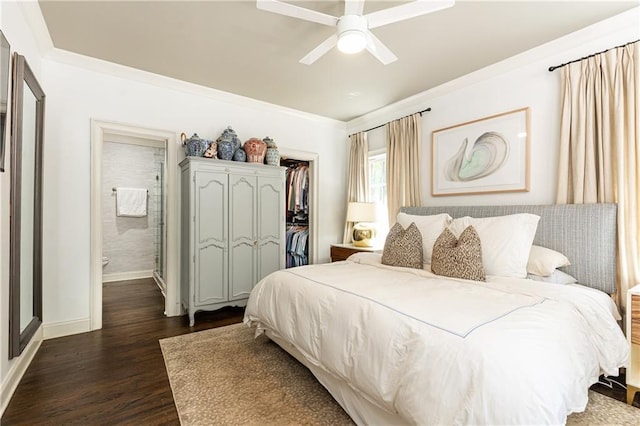 bedroom with dark wood-style flooring, ornamental molding, baseboards, ceiling fan, and a closet