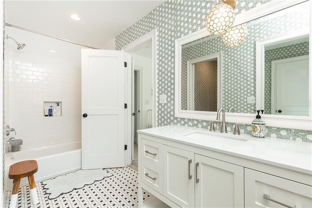 full bathroom featuring wallpapered walls, vanity, and bathtub / shower combination